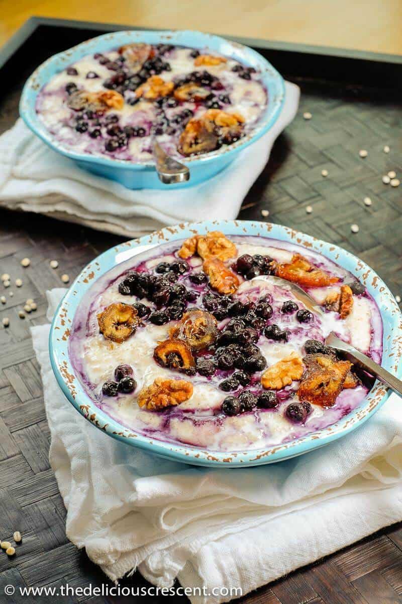 Barley Porridge in two blue bowls placed on a tray