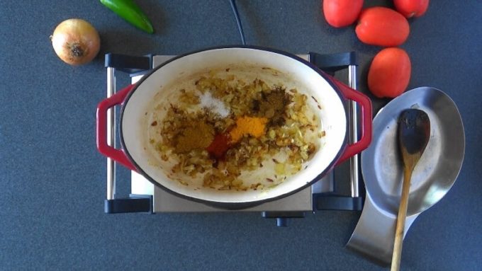 Onions sauteed in oil and spices added for making the curry.