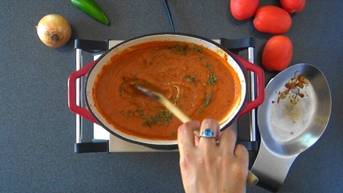 Yogurt and fenugreek leaves added to crushed tomatoes and spices to make the sauce.