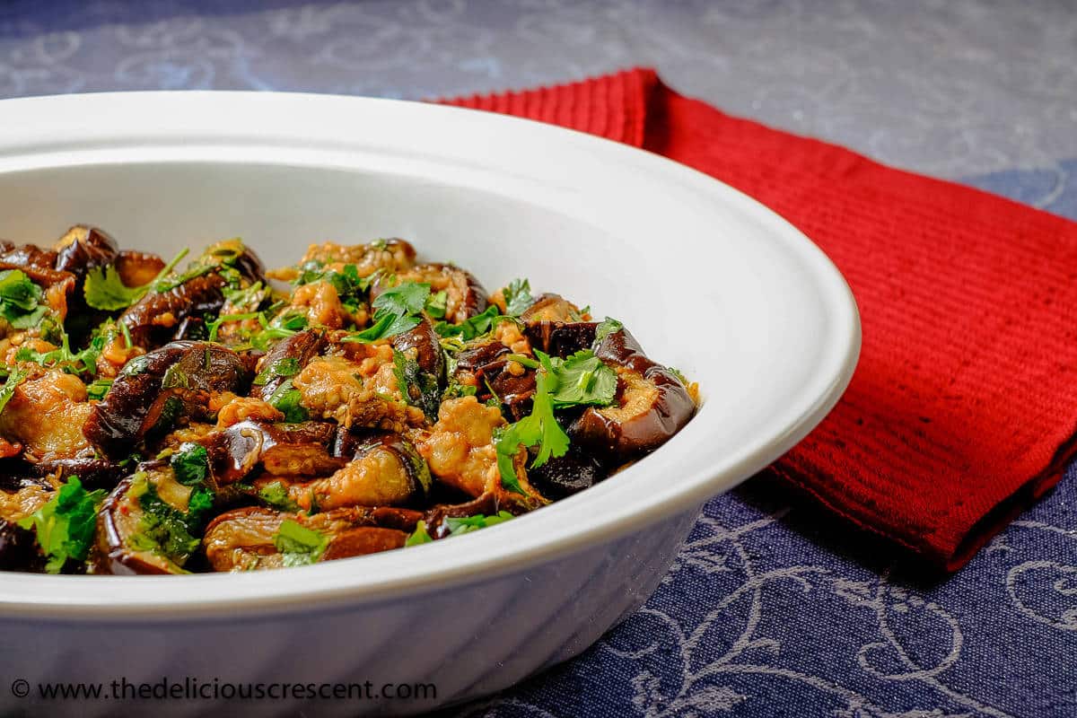 Moroccan eggplant salad smothered in chermoula and served in a white dish.