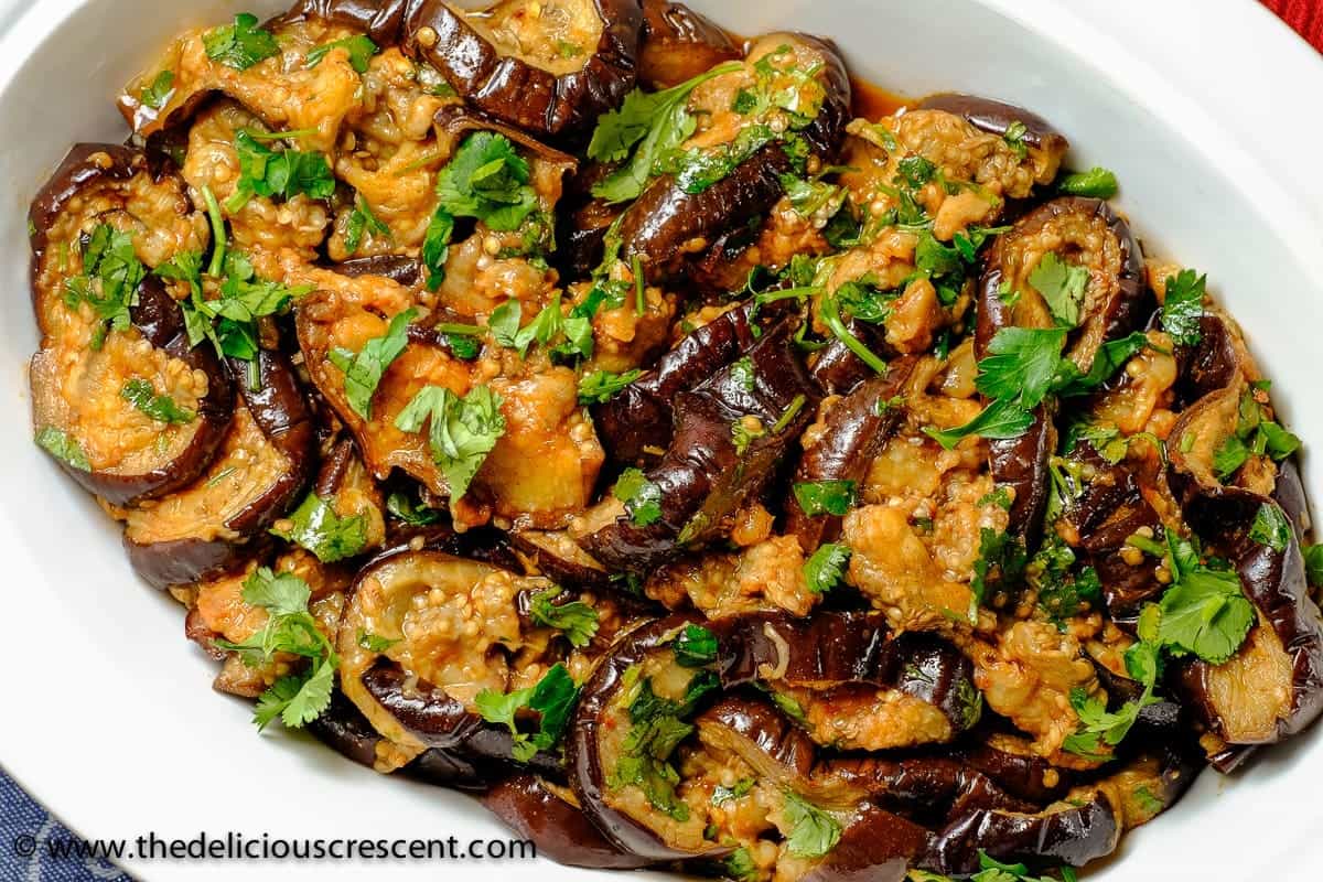 Eggplant salad prepared with chermoula and topped with herbs.