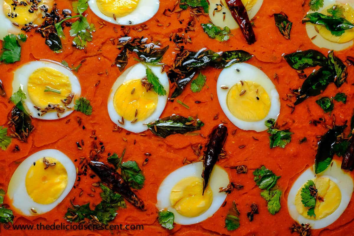 Overhead view of tamatar ka kut served in a dish.