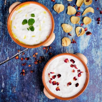 Close up view of Persian yogurt dip served in two bowls.