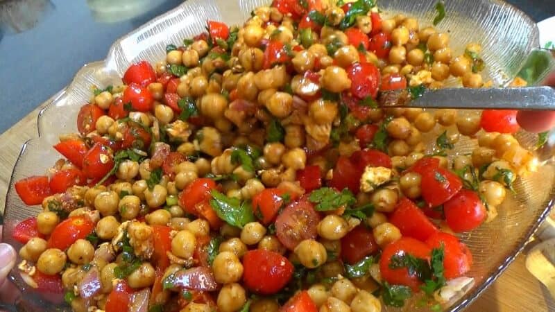 Mixing salad dressing with other ingredients for the Mediterranean Chickpea Salad