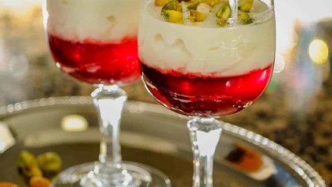 Rice custard with pomegranate jelly in a serving cup.