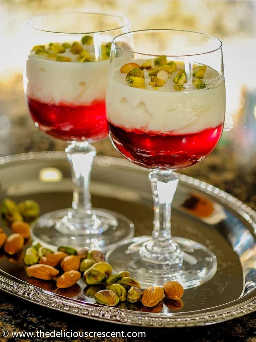 Rose rice custard with pomegranate jelly served in cups.