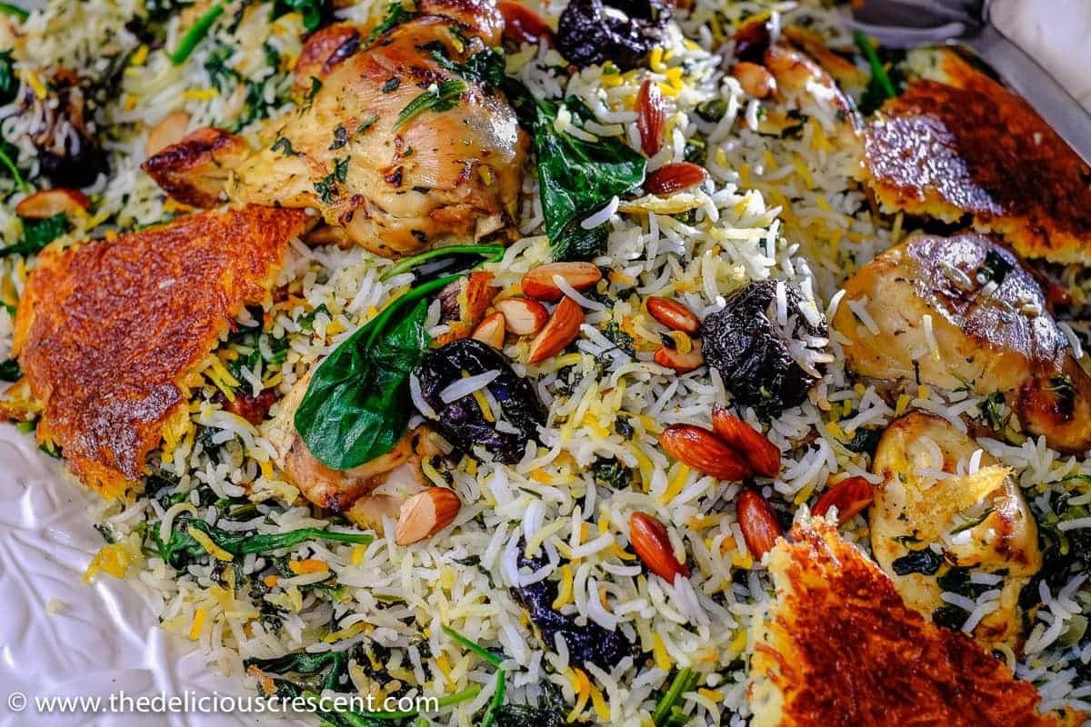 Close up view of Saffron Yogurt Rice with Spinach and Prunes, a classic Persian dish referred to as Tahchin e Esfanaj.
