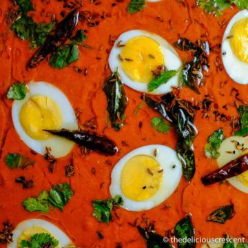 Hyderabadi tomato curry with eggs in a serving dish.