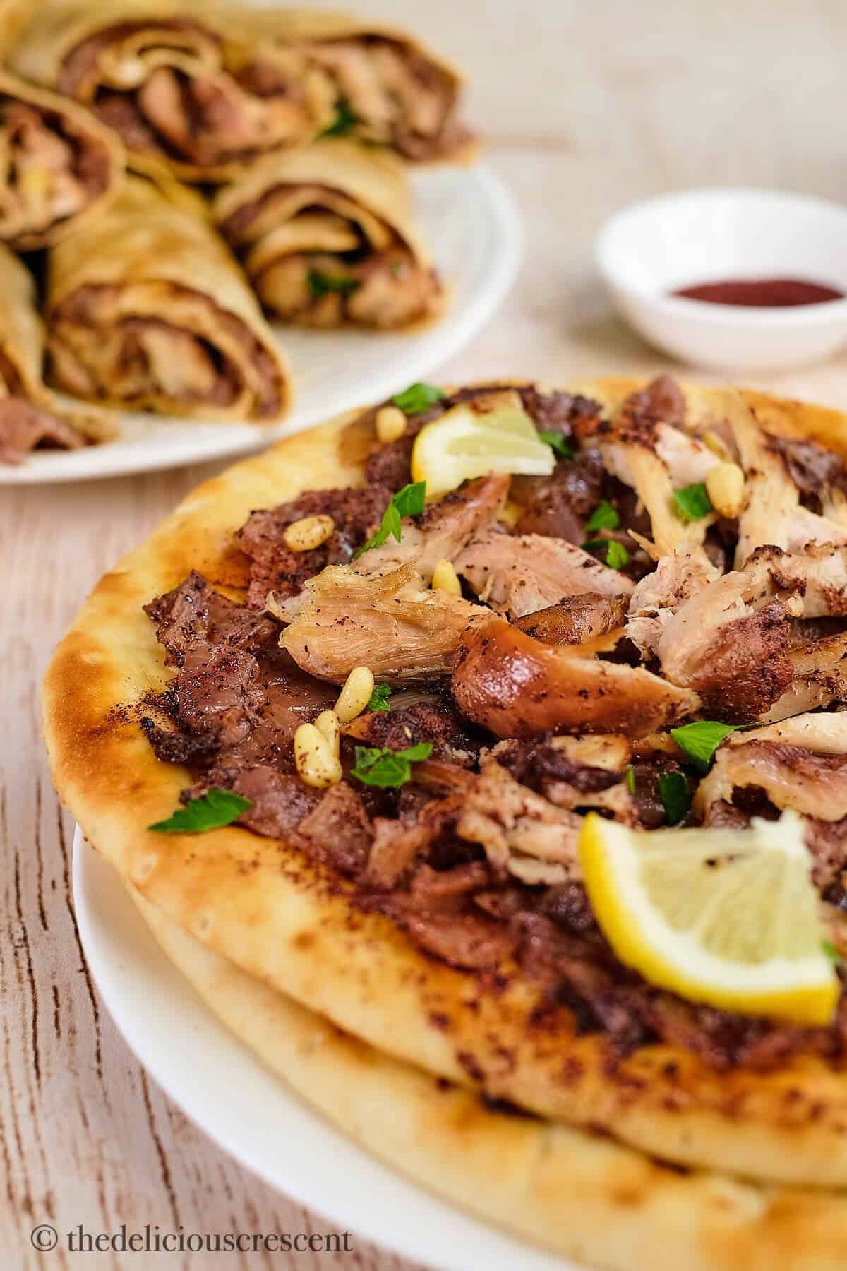 Palestinian sumac chicken onion flatbread served on the table.