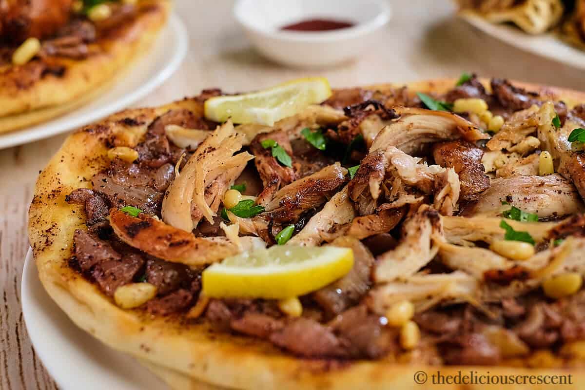 Delicious musakhan topped with shredded chicken.