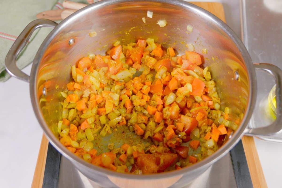 Vegetables and aromatics cooked in a pot.