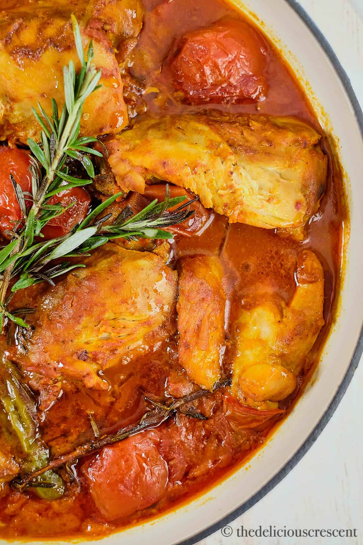 Braised tomato chicken cooked with rosemary.