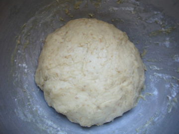 kneaded dough ball in a large bowl.