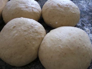Yeast based dough balls placed on a counter.
