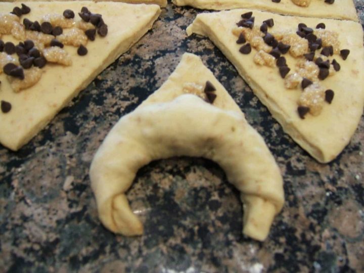 A crescent roll being shaped.