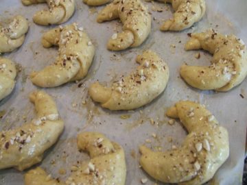 Crescent rolled shaped and placed on a baking sheet.