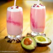 Rose flavored Moroccan avocado smoothie served in two glasses.