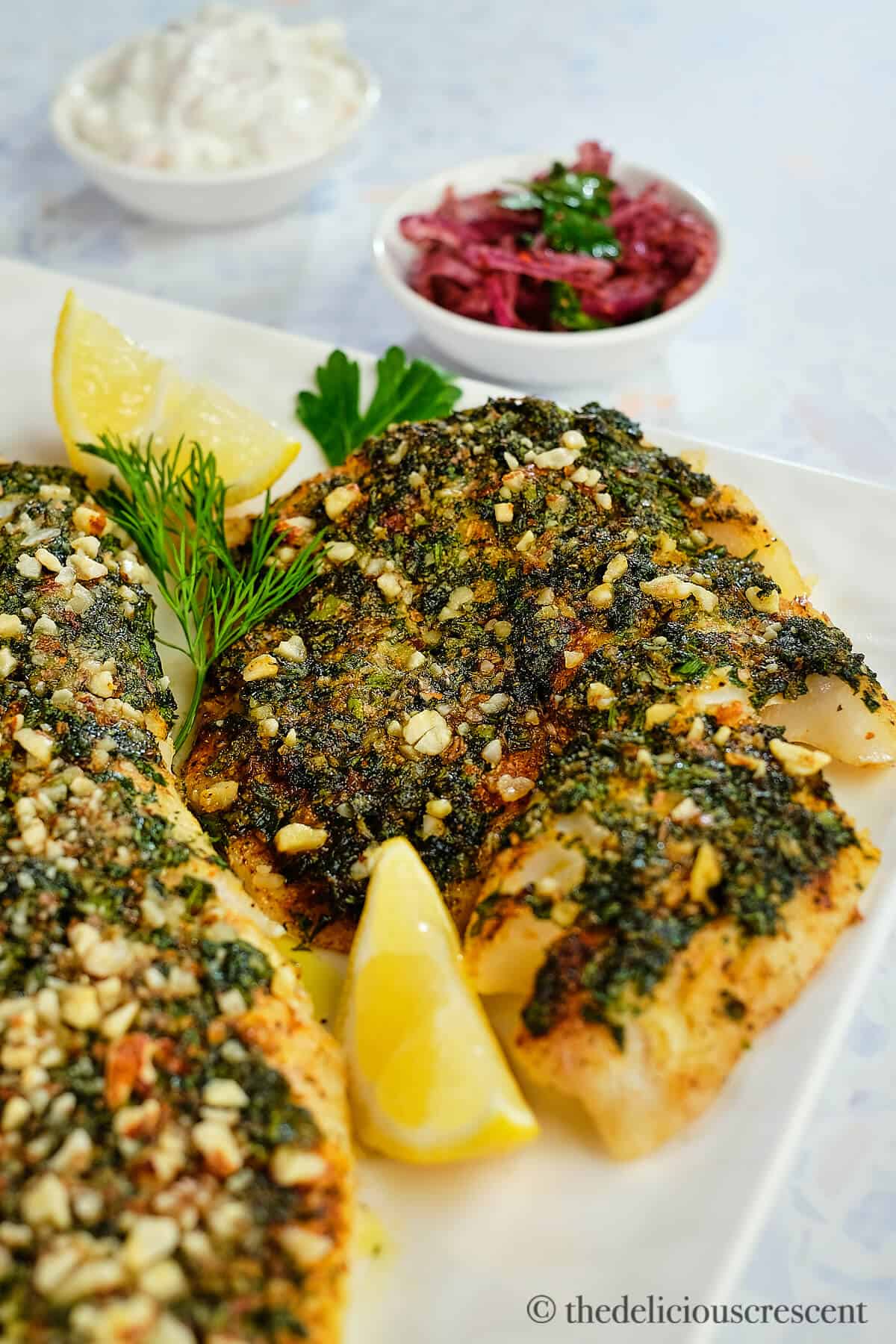 Herb crusted haddock baked and served on the table.