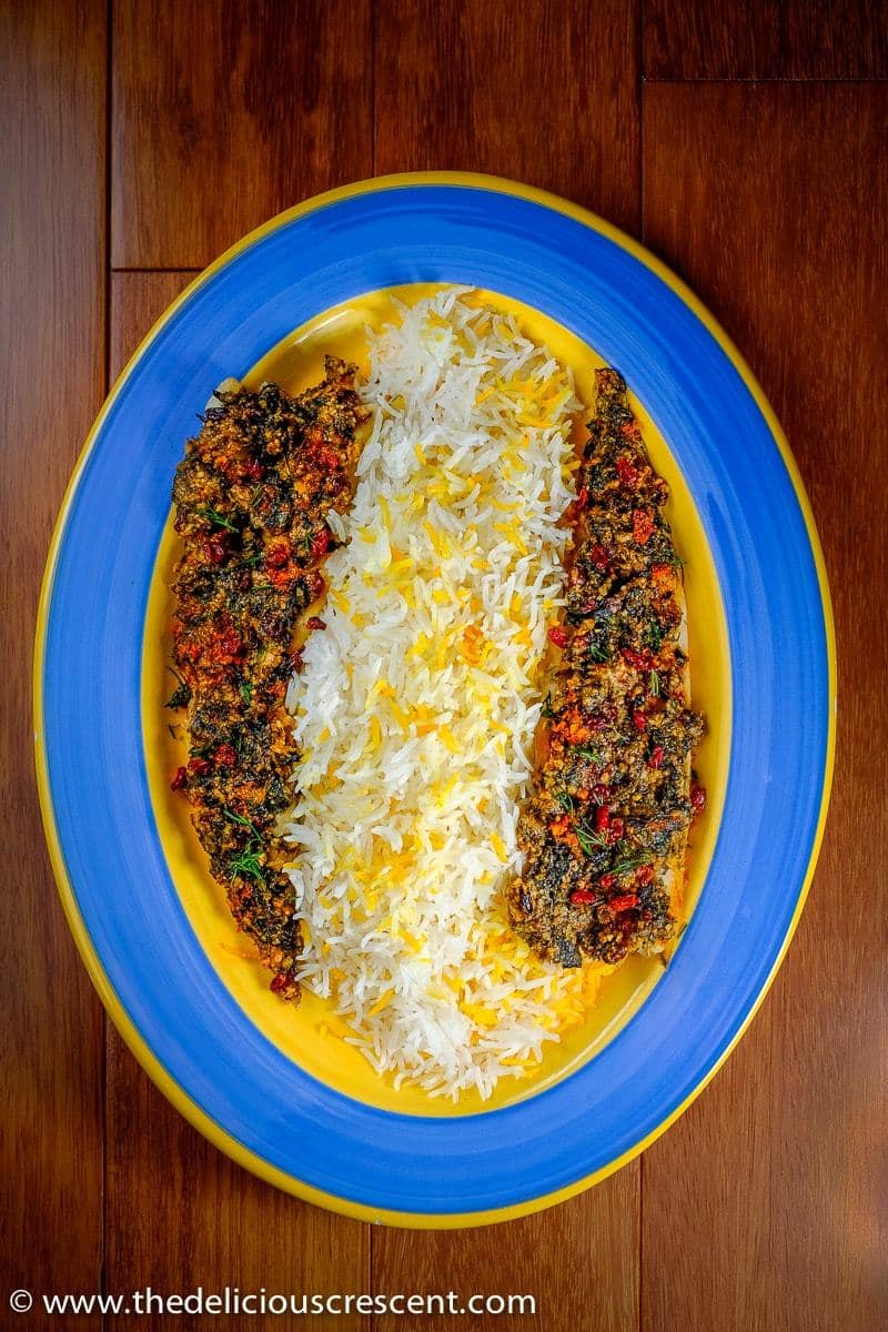 Almond Herb Crusted Baked Fish served with rice on a plate
