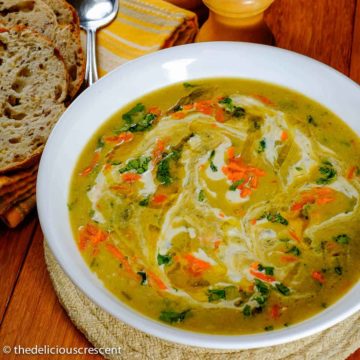 Creamy barley soup served in a white bowl.