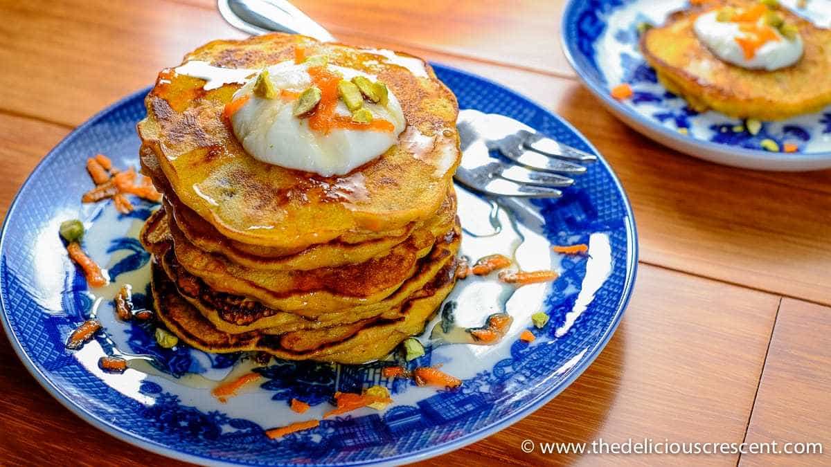 A stack of carrot pancakes served on a plate.