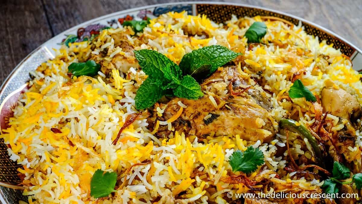 Close up view of marinated chicken steamed with rice and served on a plate.