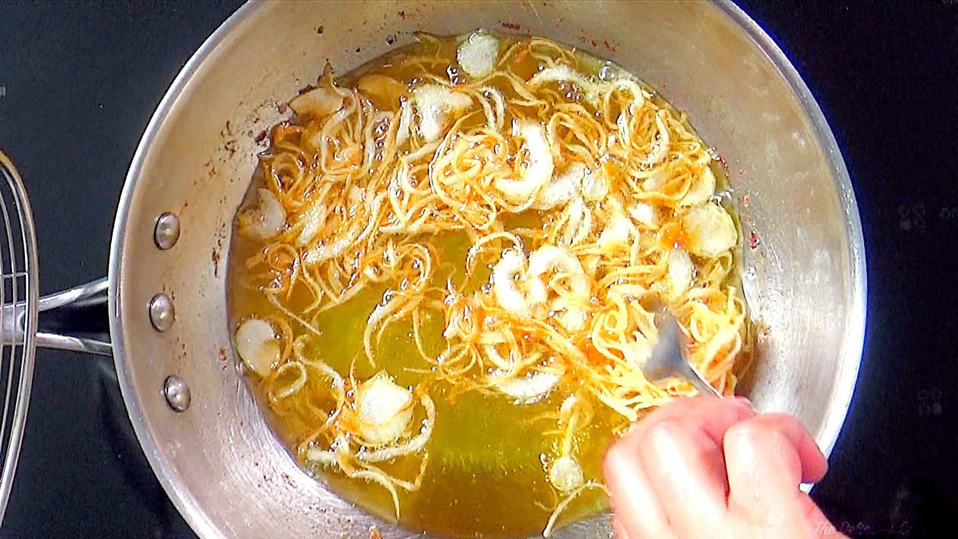 Frying onions for the recipe.