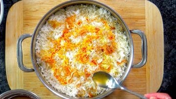 Cooked rice layered over marinated chicken and topped with saffron water.