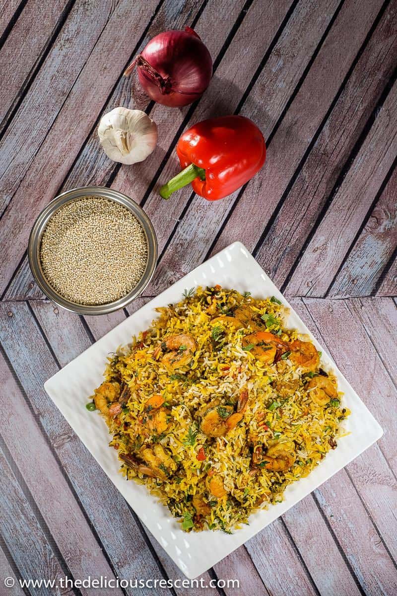 Overhead view of Persian style shrimp and rice served on a white plate and placed on a table.