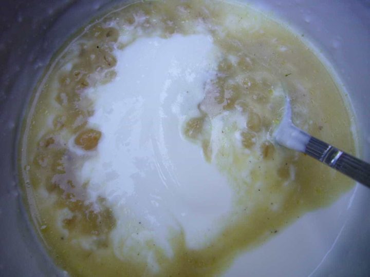 Yogurt being added to the chickpea barley soup.