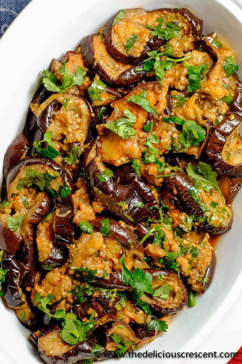 Moroccan eggplant salad smothered in chermoula and served in a white dish.