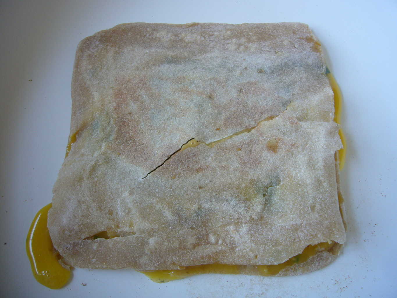 Fold over the top layer of the flatbread to make egg paratha.