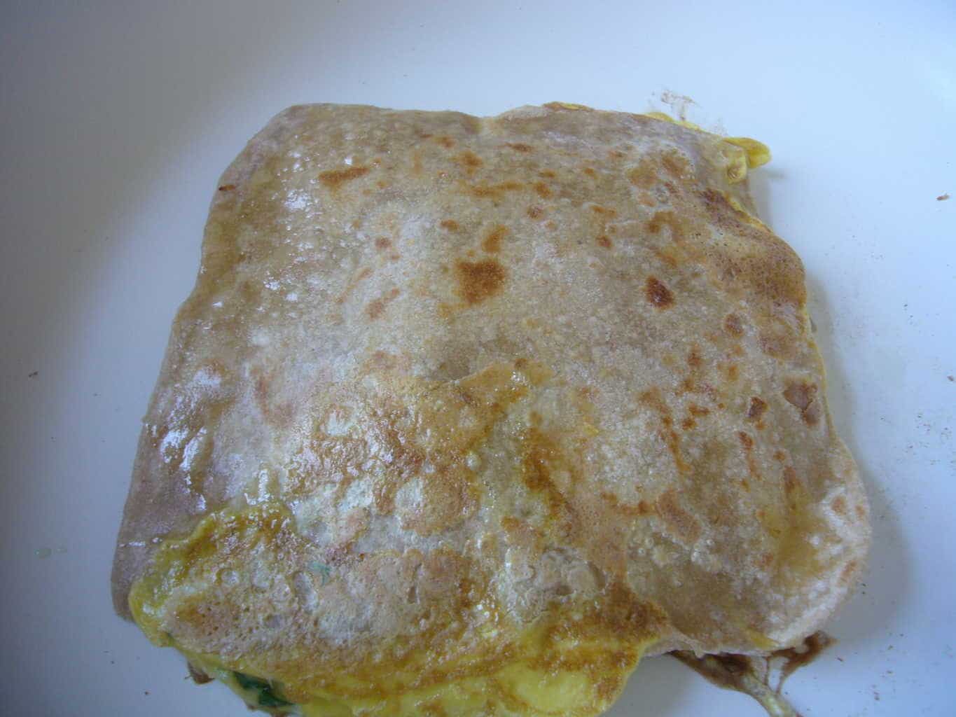 The egg paratha after it has been cooked on both sides.