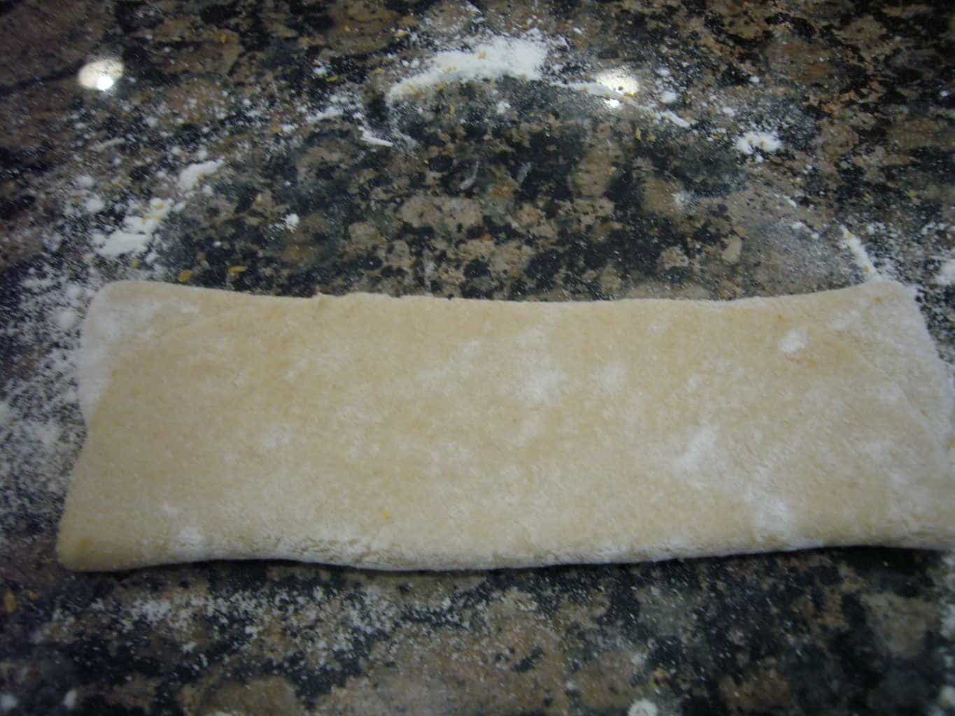 The other side of the dough is also folded over to make the paratha.