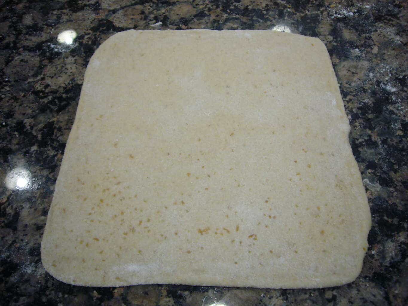 Roll it out into a 6 inch square layered bread for making egg paratha.