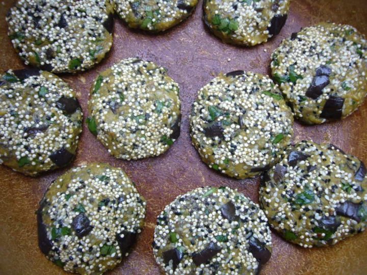 Eggplant chickpea patties with seeds on top.