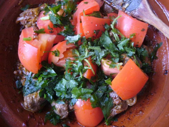Tomatoes and herbs added to braised meat.