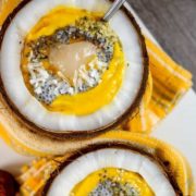Mango smoothie with chia seeds served in coconuts.