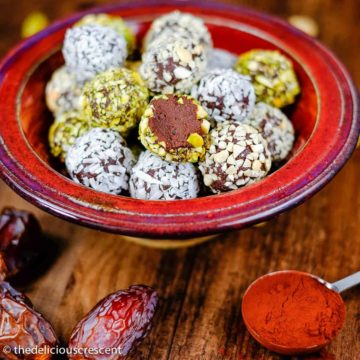 Chocolate date avocado truffles arranged in a bowl.