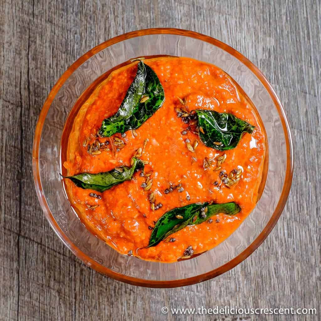 Overhead view of an Indian chutney made with red peppers and walnuts.