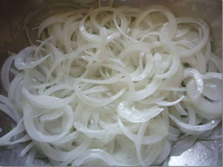 Sliced onions being sauteed.