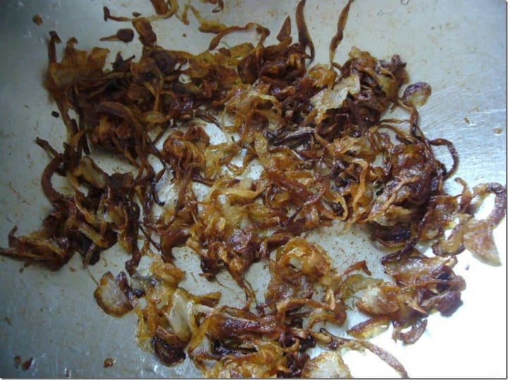 Onions nicely fried in a cooking pan.