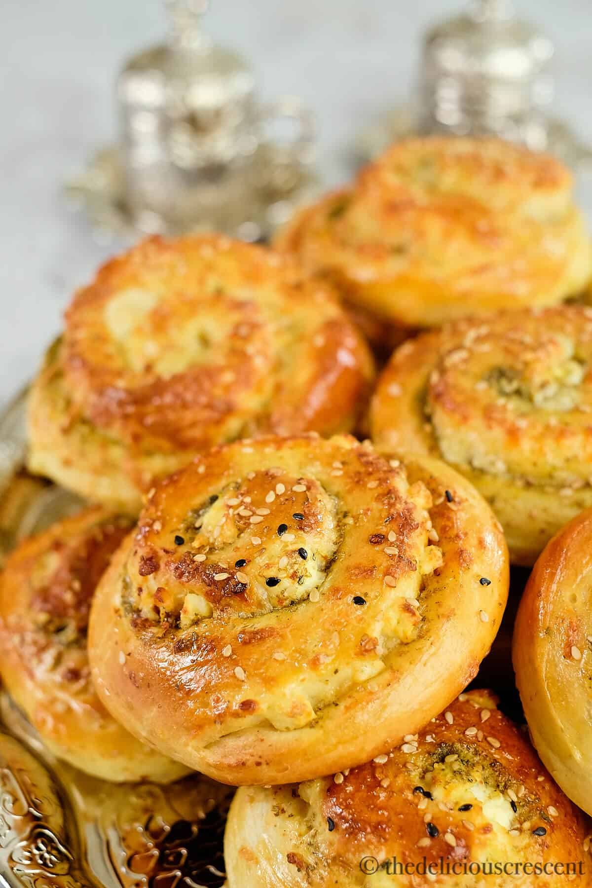 Zaatar bread rolls stacked on a plate.