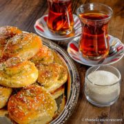 Zaatar bread rolls served on a plate along with tea.
