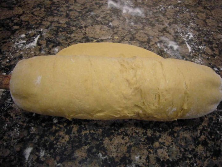 Dough rolled out for making bread rolls.