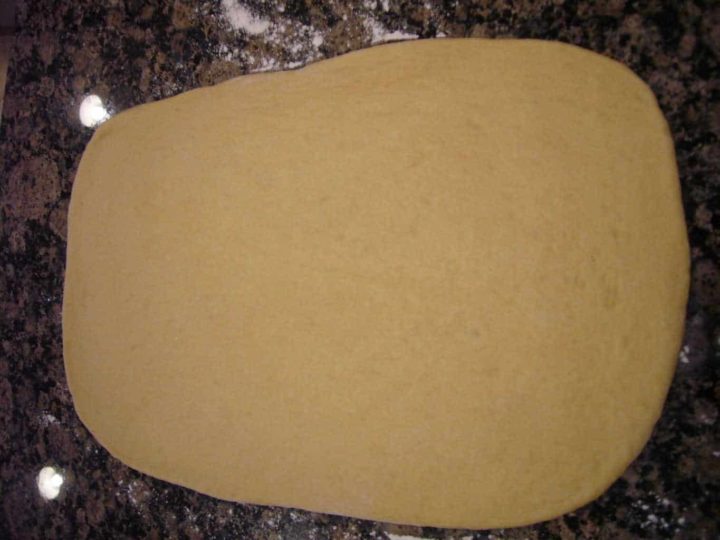 Rich dough flattened out in a rectangle shape.