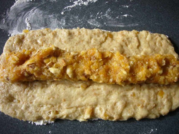 Apricot marzipan filling placed on stollen dough.