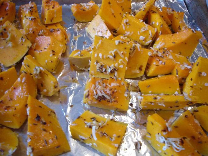 Butternut squash tossed with coconut flakes, spices and oil.