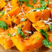 Spice roasted butternut squash drizzled with a yogurt sauce and served on a plate.