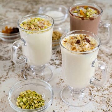 Close view of middle eastern thin pudding drink with a variety of toppings.